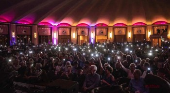  In the old days for a special moment like this which if we’re remembering correctly was to honor and remember those Lost to Covid .. it used to be candles or lighters .. now it’s Smart Phone flashlights ..  